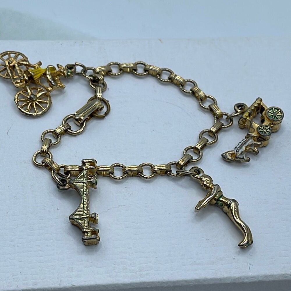 Vintage 6” charm bracelet. Gold tone with crossover clasp.